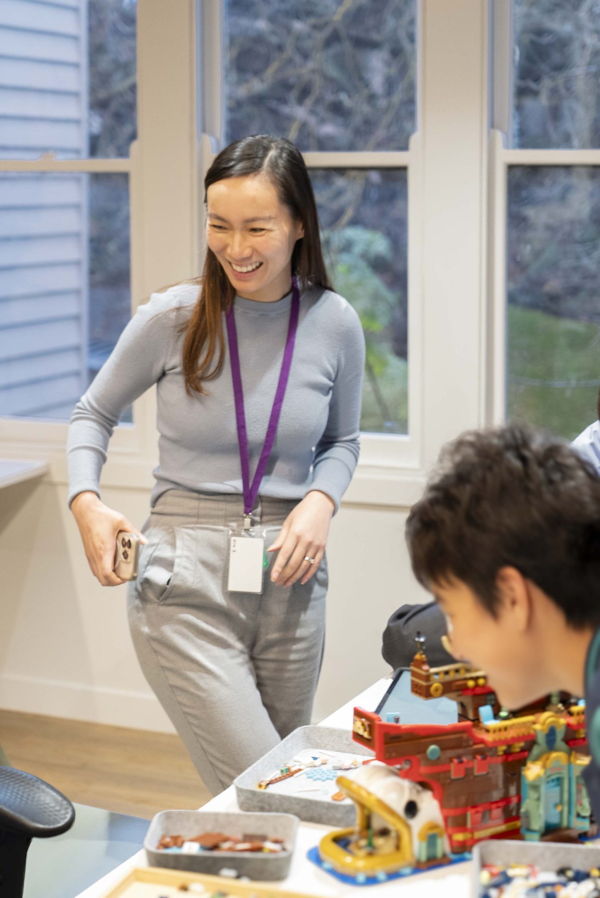 A smiling facilitator standing with children during a session